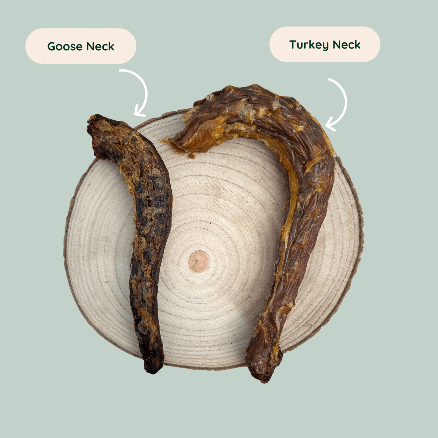 A dried goose neck and a turkey neck dog chews on a wooden plate against a green backdrop.