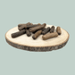 A pile of all natural pure venison sausages for dogs on a wooden slice plate against a jade green background.