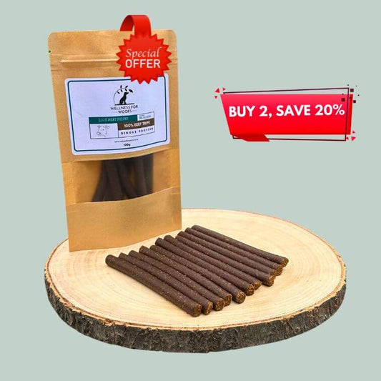 Pack of beef tripe meat sticks for dogs on a wooden plate