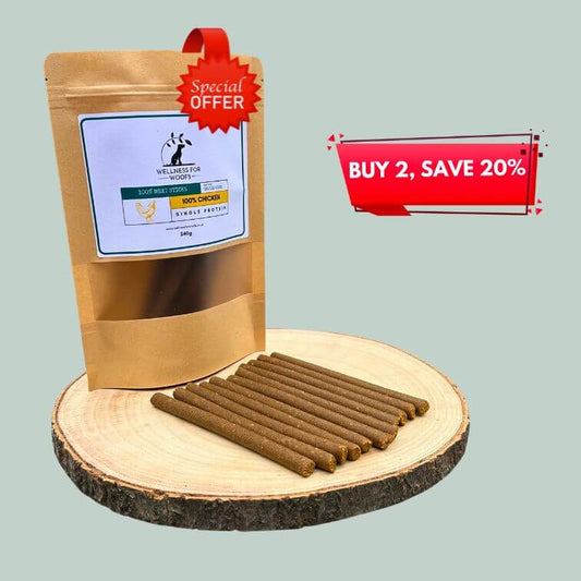 Pack of chicken meat sticks for dogs on a wooden plate
