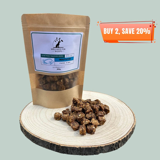 Pouch of cod and trout dog training treats with a pile of treats next to it on a wooden plate