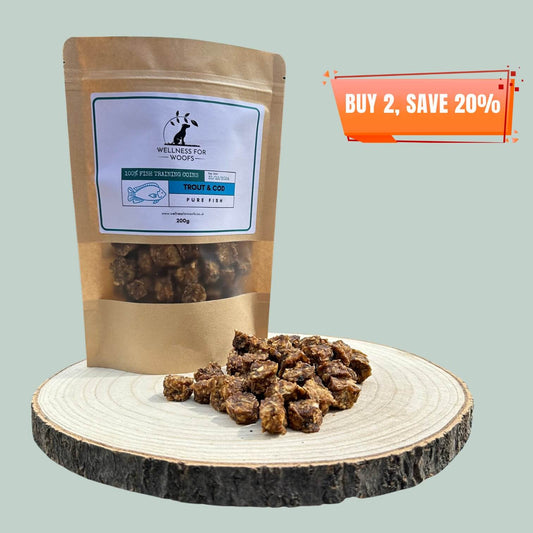 Pouch of cod and trout dog training treats with a pile of treats next to it on a wooden plate