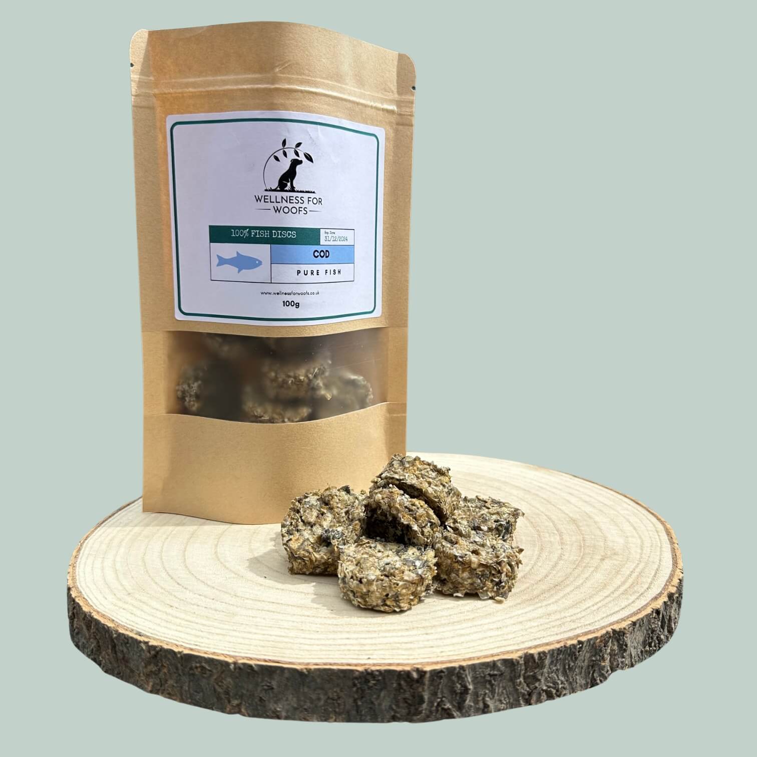 Pouch of cod disc treats for dogs next to a pile of treats on a wooden plate