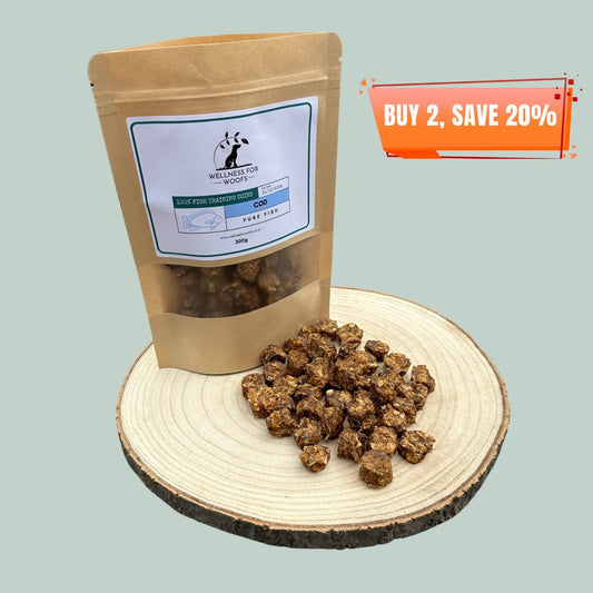 Pouch of Cod Training Treats for dogs with a pile of treats next to it, all on a wooden plate