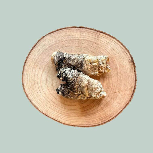 3 rolls of dried cod fish skin treats for dogs on a wooden plate