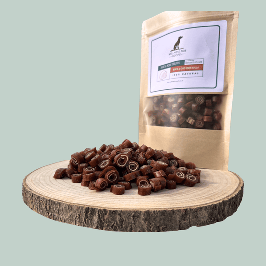 Pile of duck and cod training treats for dogs on a wooden plate with a eco-friendly pouch.