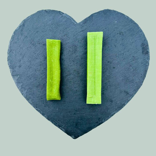 Full range of mint yak bars for dogs on a slate plate and jade green background