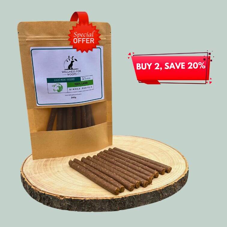 Pack of lamb meat sticks for dogs on a wooden plate