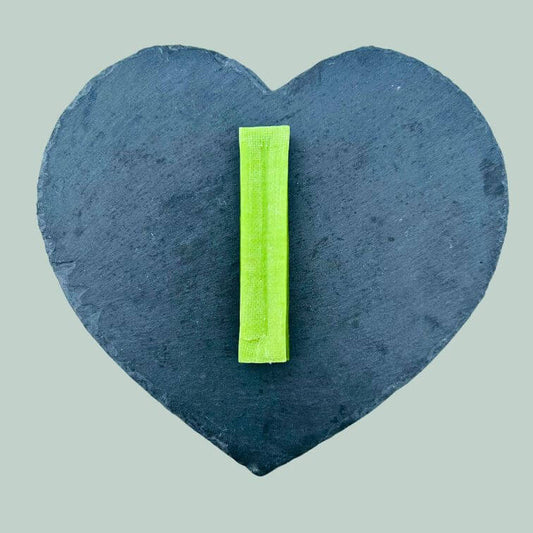 Large mint yak bar for dogs on a slate plate and jade green background