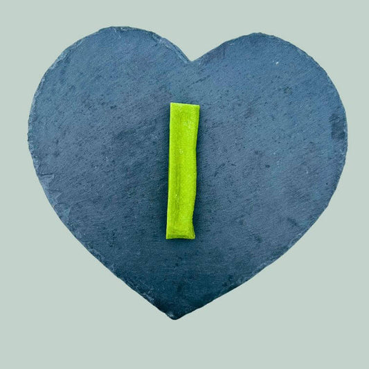 Medium mint yak bar for dogs on a slate plate and jade green background