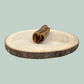 Side view of a single small roll of dried camel skin natural and healthy long lasting dog chews on a wooden slice plate against a jade green background.