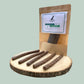 Dog treat package with treats on a wooden board against a light green background