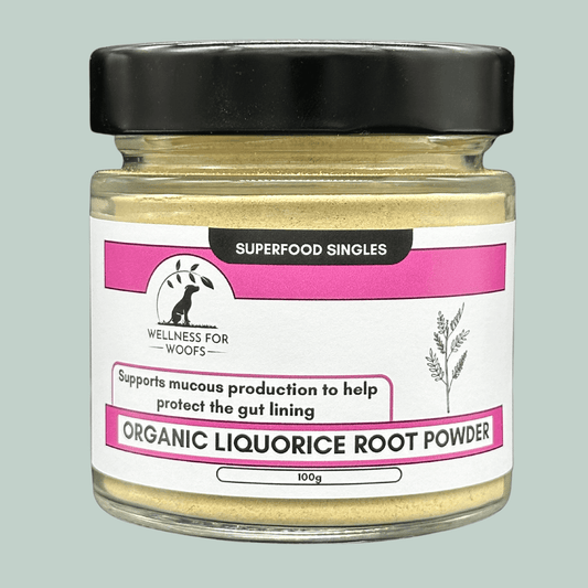 A glass jar with a pink and white label and black lid, containing Organic Liquorice Root Powder for dogs.