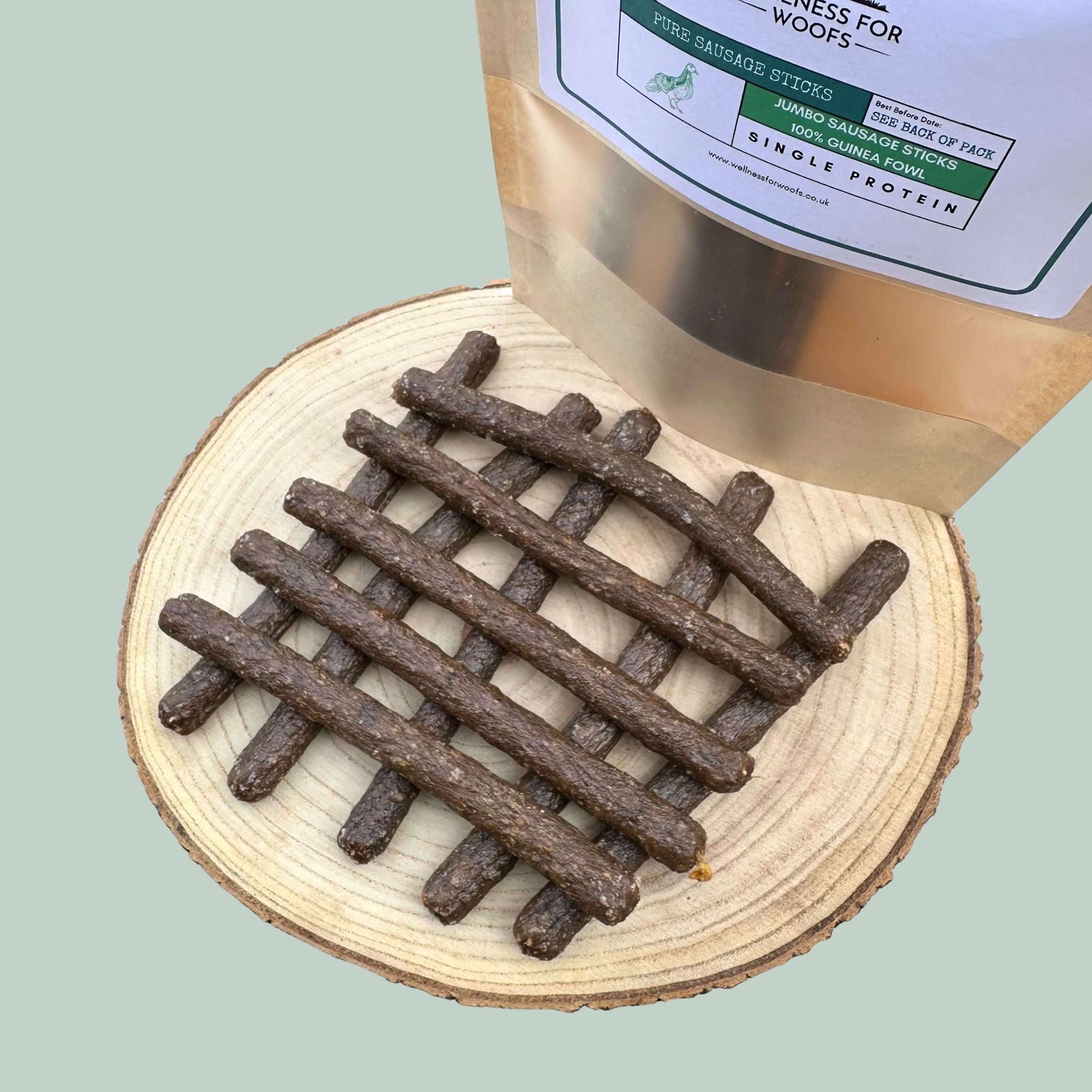 Dog treats on a wooden surface with packaging in the background