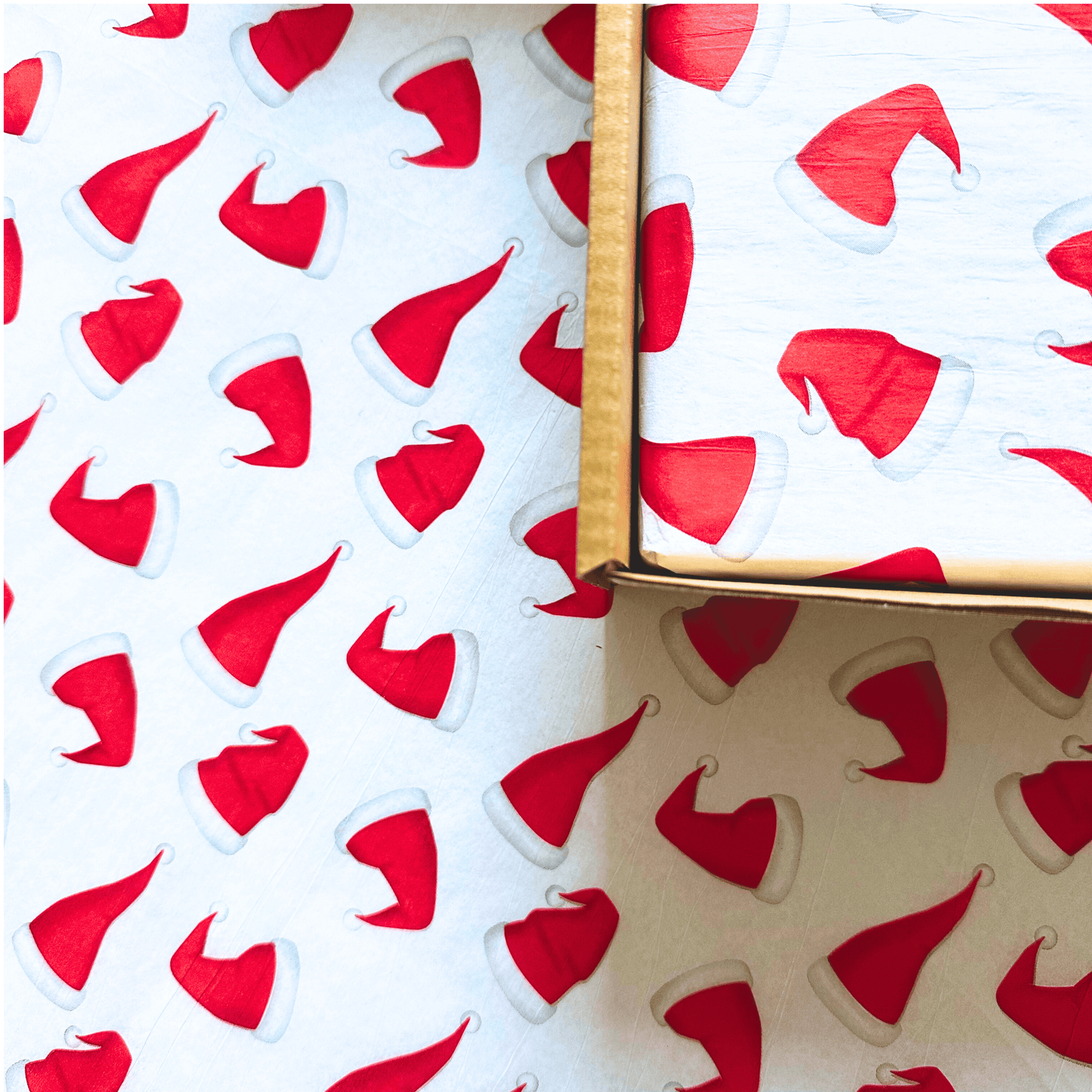 Santa Hat themed tissue paper in a Christmas treat box for dogs full of natural treats.