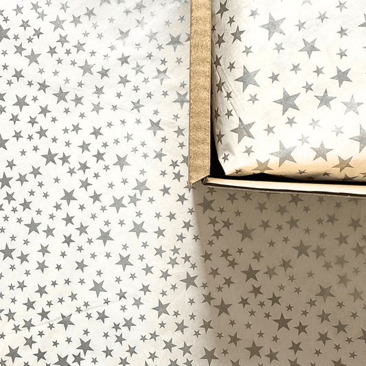 Silver star themed tissue paper for a Christmas Natural Treat Box for dogs