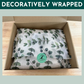 Decoratively gift wrapped box of natural dental treats and chews for dogs and puppies